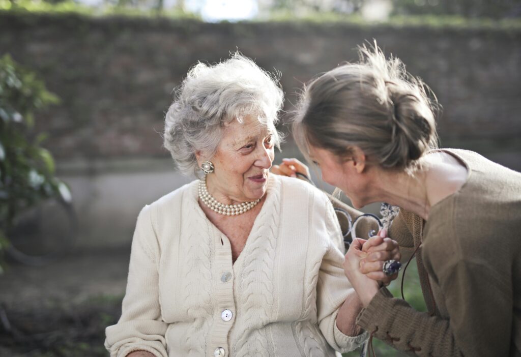 commercial-plumbing Joyful interaction between an elderly woman and her granddaughter in a sunny outdoor setting.